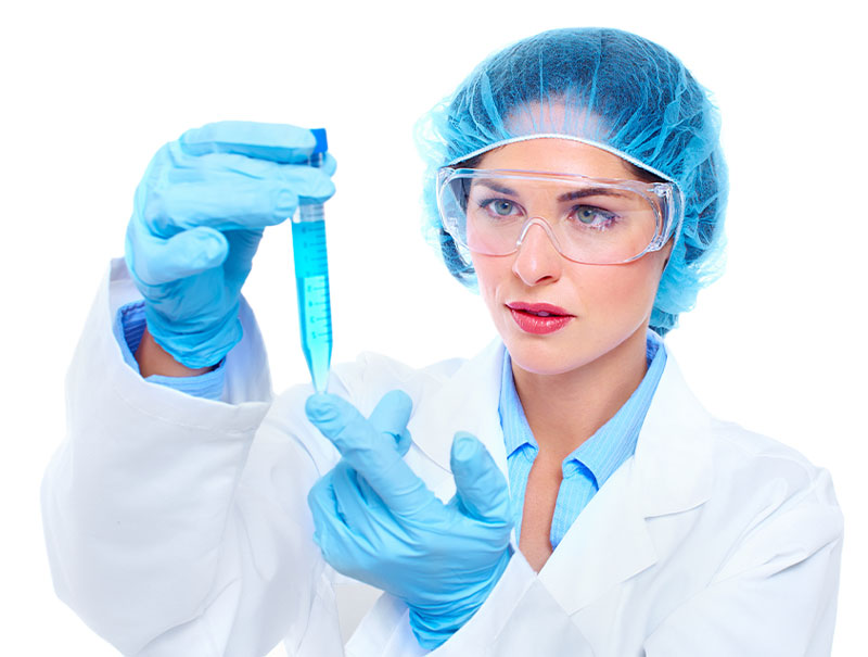 photo of female employee wearing lab gear examining test tube