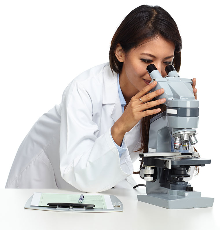 photo of female employee looking into microscope in a pharma lab