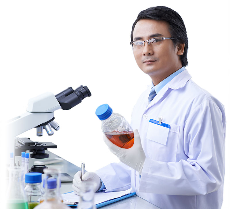 photo of male pharma employee wearing white lab coat holding test sample and writing results